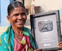 Gangavva holding Silver Play button from YouTube