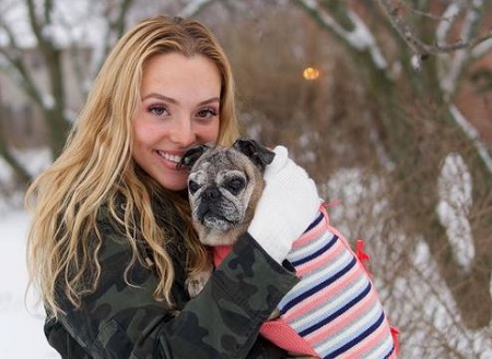 Grace Kinstler with her pet dog peanut