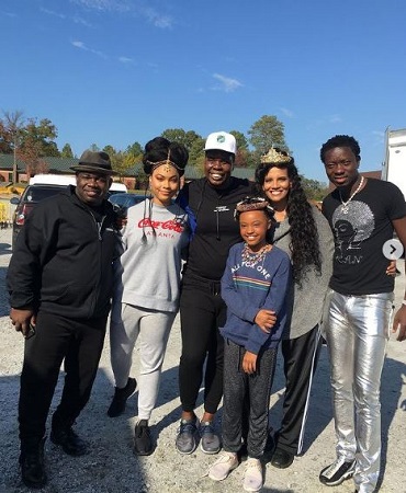 Akiley Love Wiki, Height, Age, Family, Movies, Biography & More 8 Akiley Love with the cast of Coming 2 America