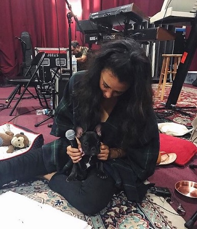 Briana Lee in her music studio with her dog