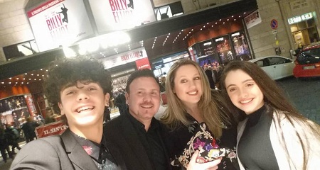 Christian Roberto takes a selfie with his family