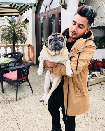 Khan Saab with his pet dog 'Romio'.