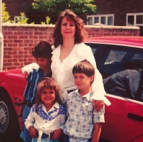 Childhood photo of Tristan with his siblings and mom