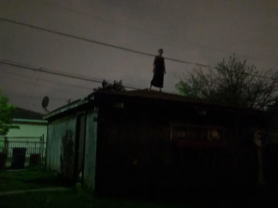 A friend went for a walk the other night and saw this woman just standing on a roof